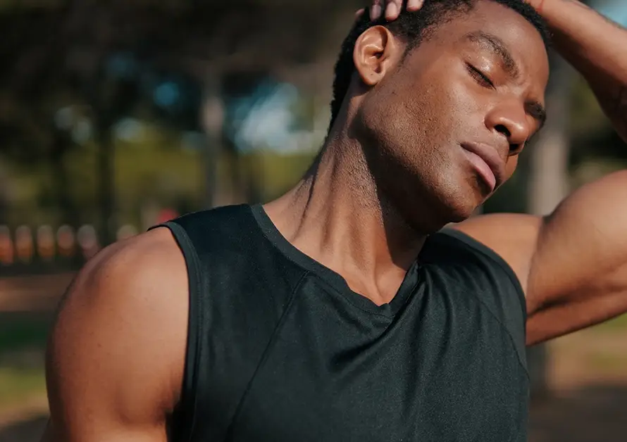 Man stretching outdoors in a park